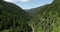 Aerial Mountain Landscape. Steep Valley covered by Trees and Mountains