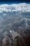 Aerial mountains and clouds top view vertical. Airplane view middle east landscape