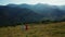 Aerial mountains couple dancing against stunning hills panorama sunny sky view