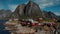 Aerial Moving traditional Norwegian fishermans cabins, rorbuer, on the island of Hamnoy, Reine, Lofoten islands, Summer