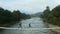 Aerial nature bridge couple running on having fun close small mountain river