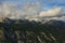 Aerial nature landscape with heavy white clouds hang over beautiful mountain range. Landscape during the autumn season