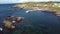 Aerial Newfoundland at a small fishing village with rocky shores and docks