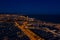 Aerial Night photo of port with yachts, Barceloneta beach, center of Barcelona and road with car traffic. Aerial view