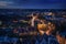 Aerial night view of the illuminated city of Luebeck, Germany in winter with Holstentor and historic Salzspeicher houses, long