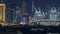 Aerial nighttime cityscape with illuminated architecture of Dubai downtown timelapse, United Arab Emirates.