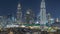 Aerial nighttime cityscape with illuminated architecture of Dubai downtown timelapse, United Arab Emirates.