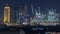 Aerial nighttime cityscape with illuminated architecture of Dubai downtown timelapse, United Arab Emirates.