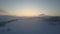 Aerial nordic winter landscape flight over snow mountain forest on sunrise. Winter drone flight over hills through a fog