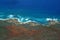 Aerial of Northwest coast of Molokai with waves crashing into sh