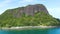 Aerial of Nosy Ankarea Madagascar over the forest past massive granite hill approaching the beach, near Nosy Be