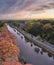 Aerial of the Nyenrode castle next to the vecht river during an amazing autumn sunset with pink colours and orange trees