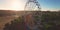 Aerial orbit shot on ferris wheel at country amusement park at sunset. colorful shot around Big wheel circle carousel