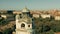 Aerial orbiting shot of the tower of historic Mullersches Volksbad public bath in cityscape of Munich, Germany