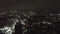 AERIAL: Over Dark Hollywood Los Angeles at Night view on Wilshire Blvd with Clouds over Downtown and City Lights