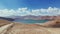 Aerial over gravel road path toward Bulunkul lake in sunny day.Pamir highway silk road travel adventure in Tajikistan