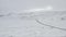 Aerial: over snow white landscape with road, mountain in Iceland Winter, Snowing, Cold, Arctic