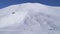 Aerial overhead tracking view of five trekkers group on snowy pathway to Tilicho lake in high altitude Himalayas