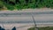 Aerial overlooking the highway with cars, trucks and other transport.