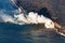 Aerial overview of area affected by fire hose shaped spill of hot lava down into the ocean in Hawaii