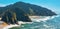 Aerial of Pacific Ocean in Oregon, Highway 101 winding through mountains.