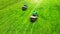 Aerial. Pair of lawn mowers on a grass. Professional gardening background with a two workers on lawnmowers