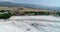 Aerial. Pamukkale - famous gleaming white calcite travertines (terraces) on the cliff. Turkey,