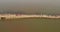 Aerial panning shot of monks and people crossing the bamboo bridge