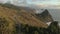 Aerial panning shot of Oregon Coast Highway 101 and sheer cliffs