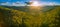 Aerial panorama of Australian forest and mountains at sunset.