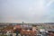 Aerial panorama of Brno, Czech Republic, with a focus on a residential suburb with skyscrapers in background, from the roofs