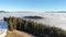 Aerial panorama of Bukovel Ski Resort mountain Dovha, Particularly covered with a Man-made Snow. Low clouds hang around