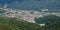 Aerial panorama of Busteni village in Prahova Valley, surrounded by forest, a popular outdoor destination in Romania