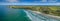 Aerial panorama of Cape Bridgewater beach, settlement, and wind farm in Victoria, Australia.