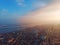 Aerial panorama of dramatic sunset above evening Voronezh city in haze or fog, bird eye view of urban downtown architecture