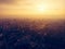 Aerial panorama of dramatic sunset over big city in evening twilight fog or haze, drone view cityscape