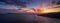 Aerial panorama drone shot of sunset burning sky clouds on Komiza town over Vis Island in Croatia Summer