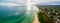 Aerial panorama of land and sea. Long pier and yachts moored at