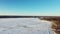 Aerial panorama of the Mille-Iles river in Laval-Ouest showing the banks of St-Eustache and it`s church with drone and coming dow