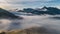 Aerial panorama of misty mountains landscape with foggy clouds motion fast in beautiful nature at sunrise Hyper lapse