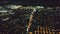 Aerial panorama of night city business center in slow motion. Urban metropolis centre in neon lights