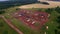 Aerial panorama of oil pumps at oilfield cluster. Summer morning, the working oil pumps and drilling rig among the