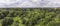 Aerial panorama over Oude Landen nature park in Ekeren, with village and harbor in the distance