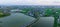 Aerial panorama: road through water storage ponds in rural countryside