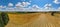 Aerial panorama of rural road passing through agricultural land in Poland countryside