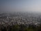 Aerial panorama of Santiago de Chile South America cityscape with fog haze smog air pollution from Cerro San Cristobal