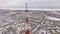 Aerial panorama of snowy city, camera is showing a tv tower