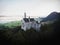 Aerial panorama sunrise view of bavarian alpine mountain landscape with Neuschwanstein fairytale castle Fuessen Germany