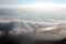 Aerial panorama of Taipei City on a foggy morning with a bird`s eye view of dense fog rolling over Guandu Plain