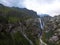 Aerial panorama of a Ushbi Waterfall among the Caucasian mountains, Stormy flow of mountain river Dolra. Summer vacation, hiking